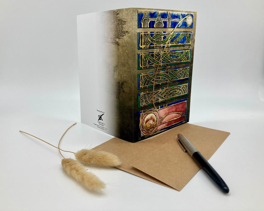 Decorative box with intricate designs, a pen, and a card on a white background