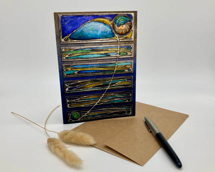 Decorative greeting card with peacock feather design on a white background
