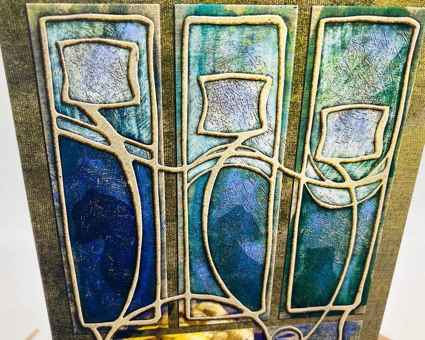Decorative tile with abstract design in blue, green, and gold on a white background