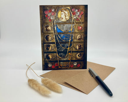 Decorative greeting card with artistic design, envelope, and pen on a white background