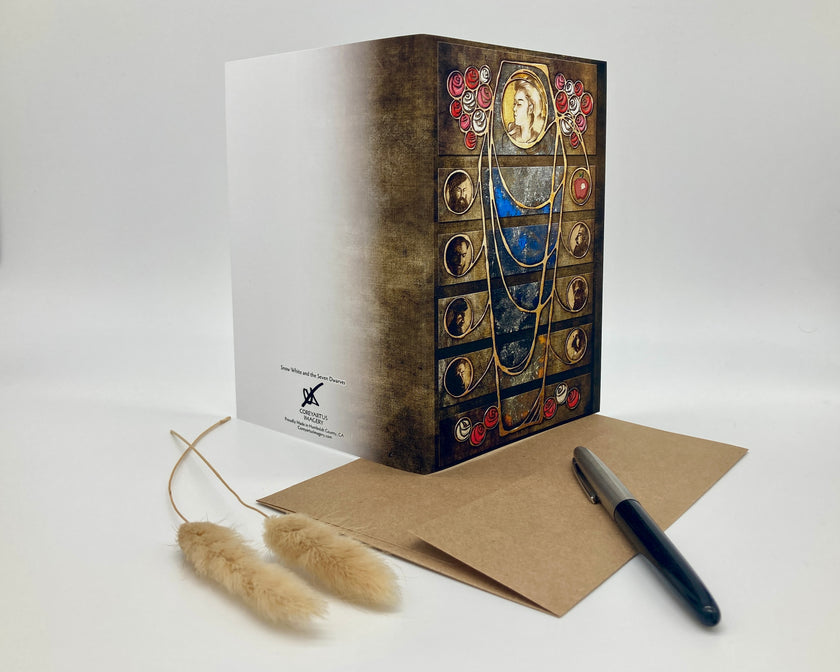 Decorative book with artistic cover design, accompanied by a pen and card on a white background