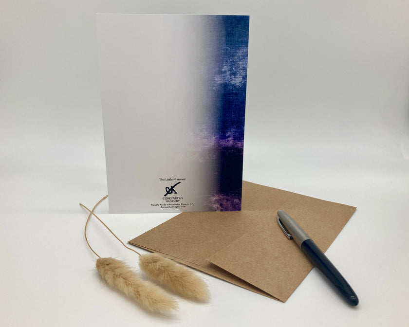 Greeting card with a pen, envelope, and decorative elements on a white background
