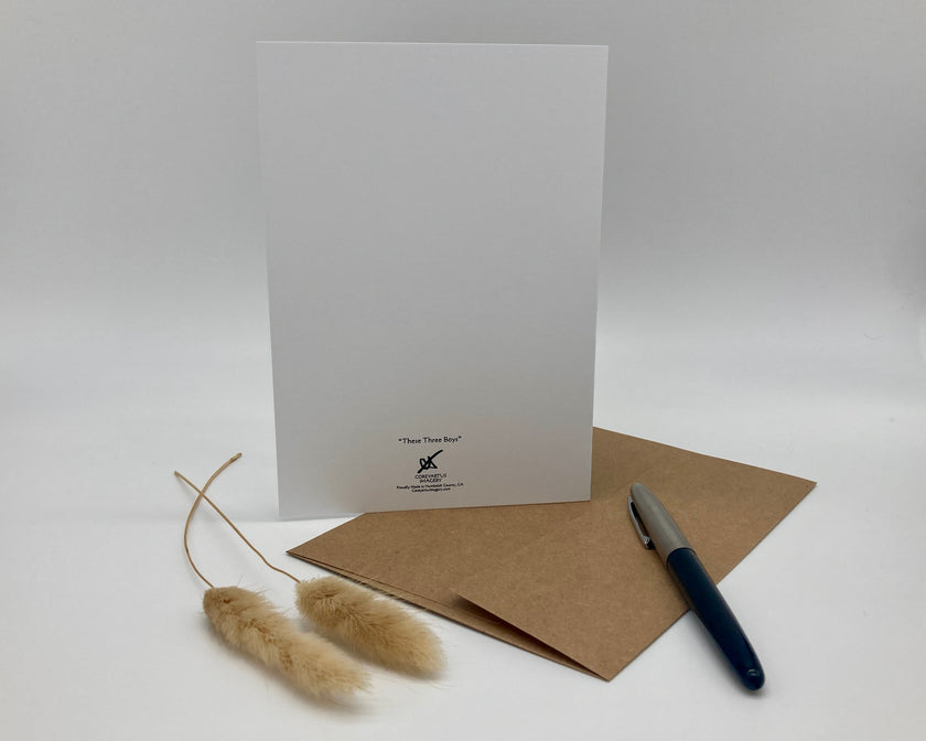 White greeting card with brown envelope and pen on a white background