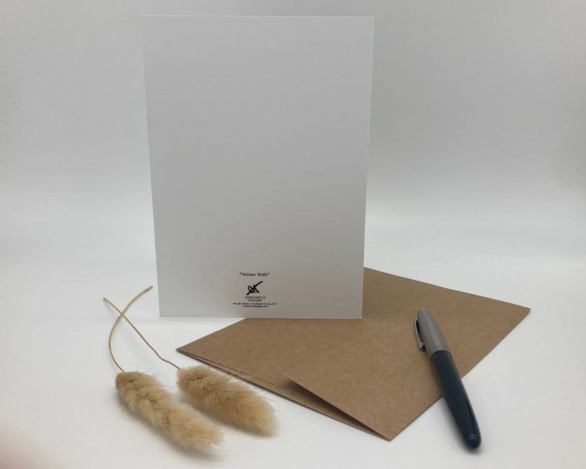 White greeting card with a brown envelope and pen on a white background