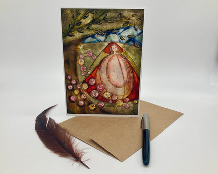 Artistic greeting card with a woman and flowers, accompanied by a pen and feather on a white background.