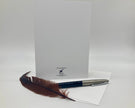 Feather pen and letterhead on a white background
