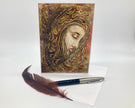 Decorative greeting card with artistic design of a face, feather pen, and white paper on a light background