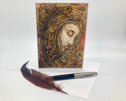 Decorative greeting card with artistic design of a face, feather pen, and white paper on a light background