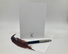 Feather pen and letterhead on a white background