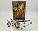 Decorative greeting card with artistic design on a white background, accompanied by a pen and decorative branch.