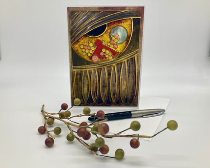 Decorative greeting card with artistic design on a white background, accompanied by a pen and decorative branch.