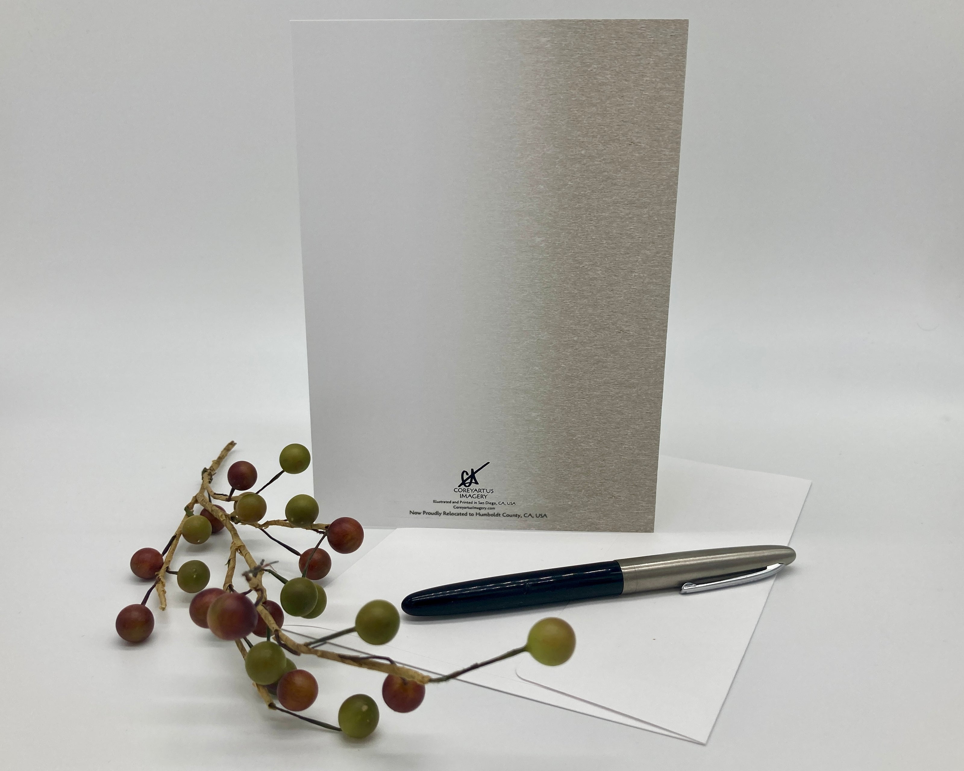 Greeting card with pen and decorative branch on a white background
