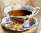 Decorative teacup with floral design on a matching saucer against a textured background