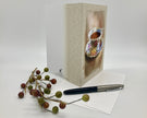 Greeting card with teacup design, pen, and decorative branches on a white background