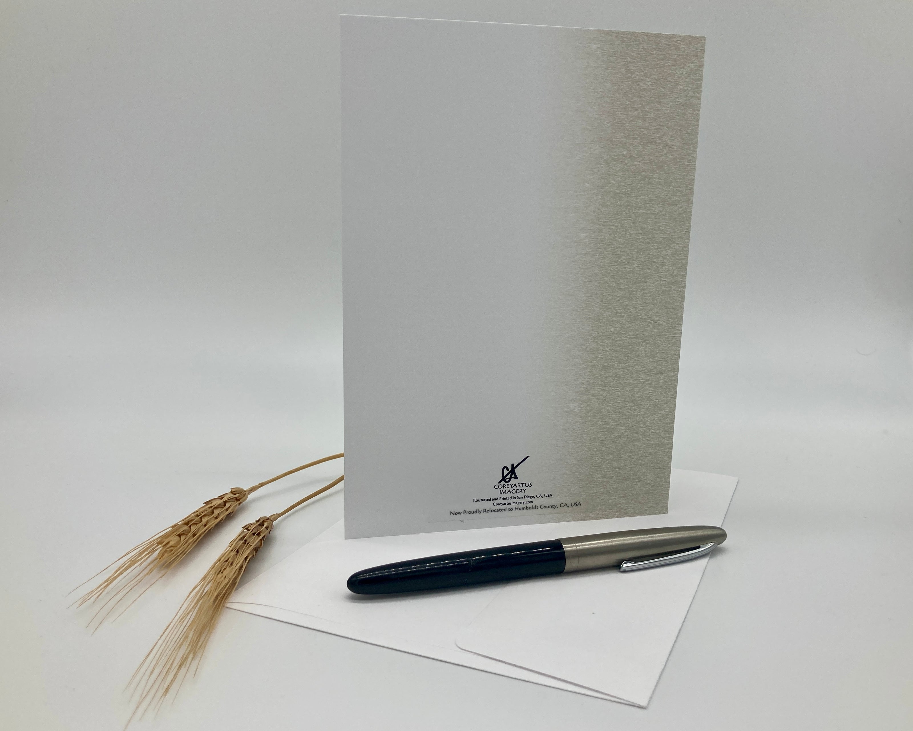 White card with a pen and wheat on a white background