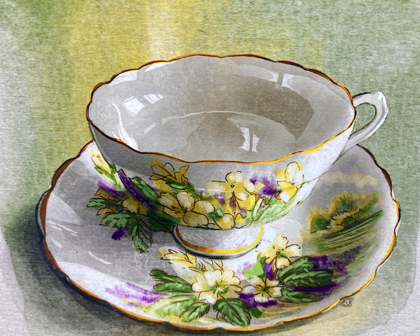Decorative teacup and saucer with floral patterns on a textured green background