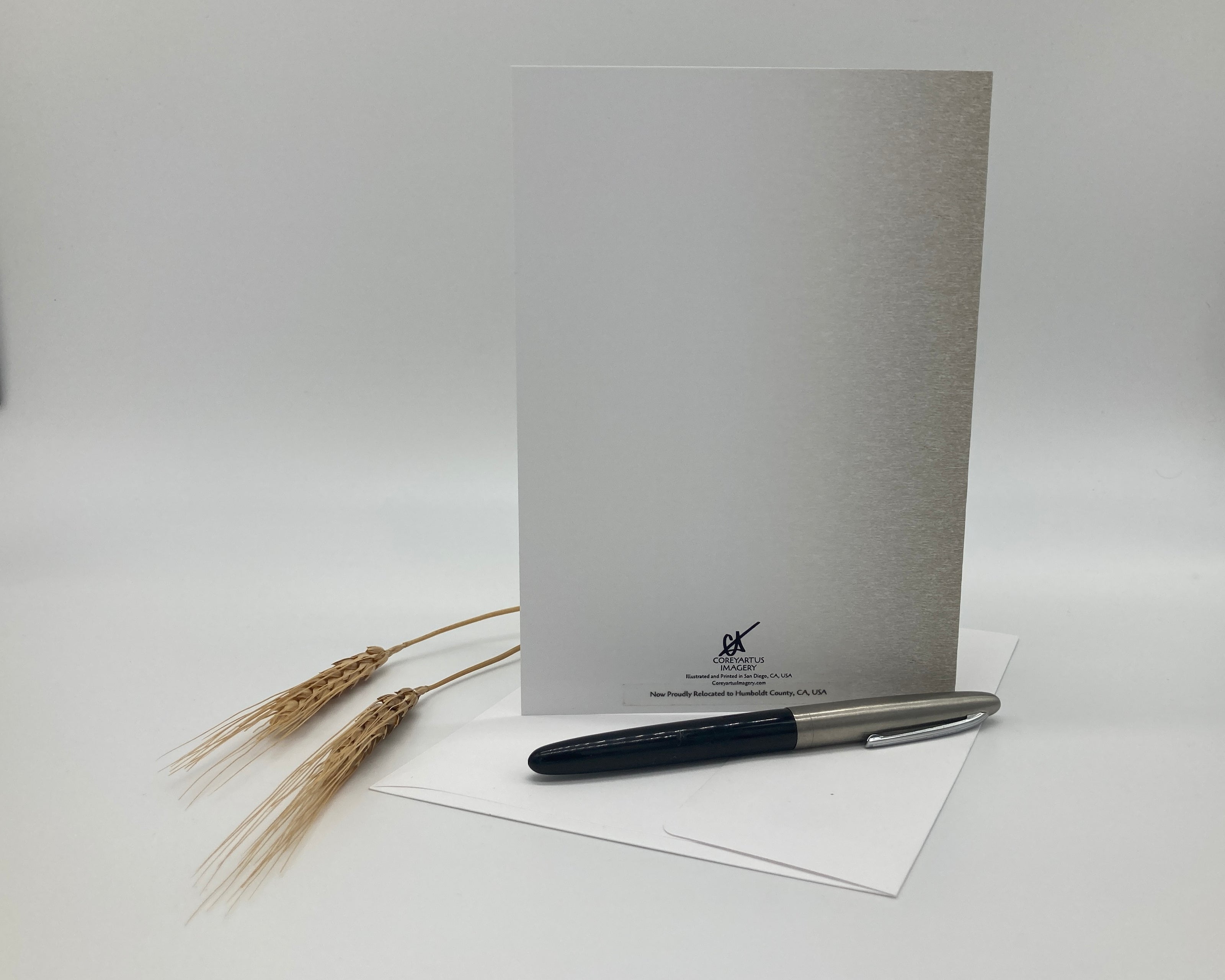 White card with a pen and wheat on a white background
