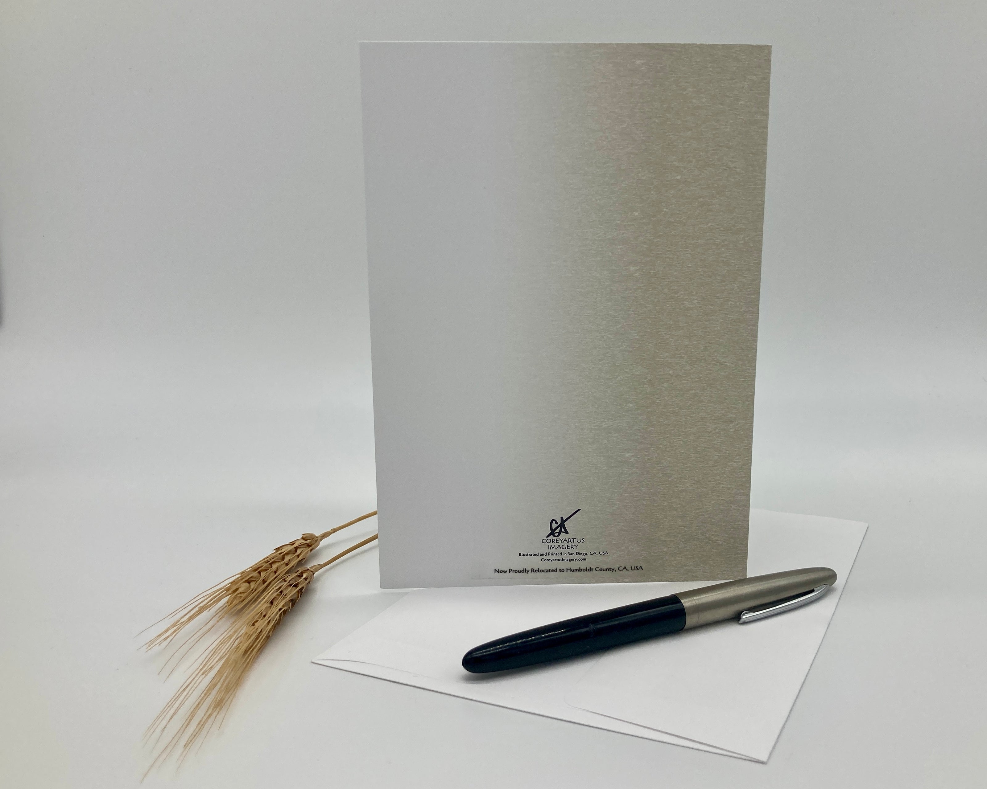 Greeting card with pen and paper on a white background