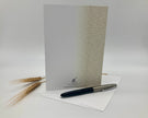 Greeting card with pen and wheat on a white background