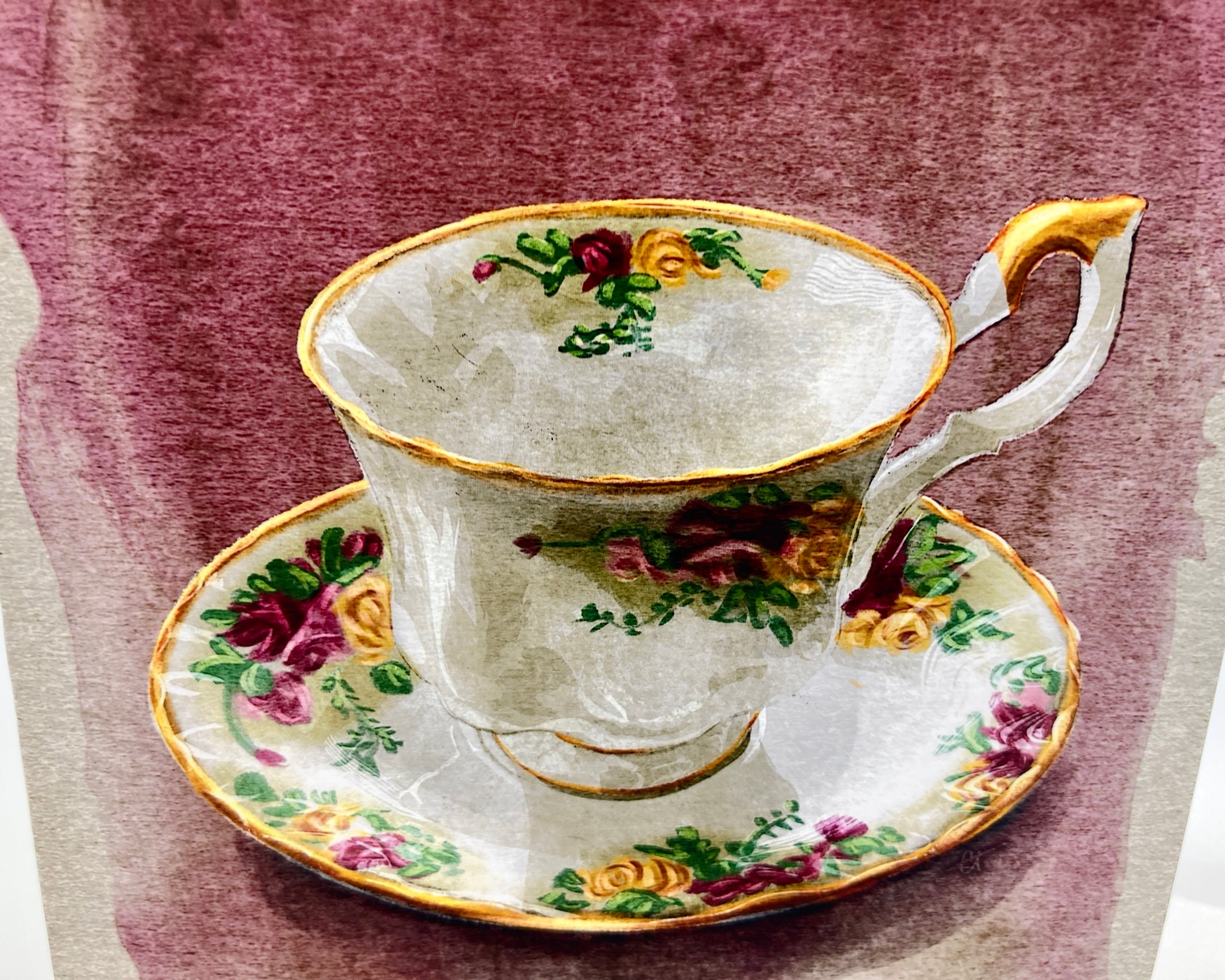 Decorative teacup and saucer with floral patterns on a textured background
