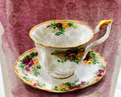 Decorative teacup and saucer with floral patterns on a textured background