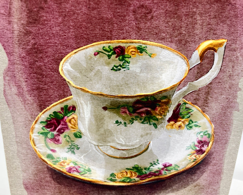 Decorative teacup and saucer with floral patterns on a textured background
