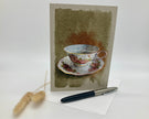 Greeting card with a teacup design on a plain background