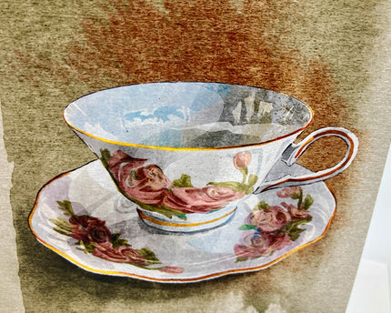 Decorative teacup and saucer with floral design on a textured brown background