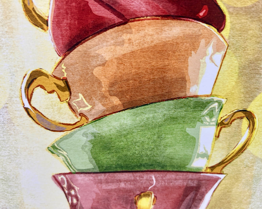 Three ceramic teacups in red, gold, and green on a textured beige background