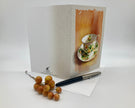 Greeting card with a teacup design, pen, and berries on a white background