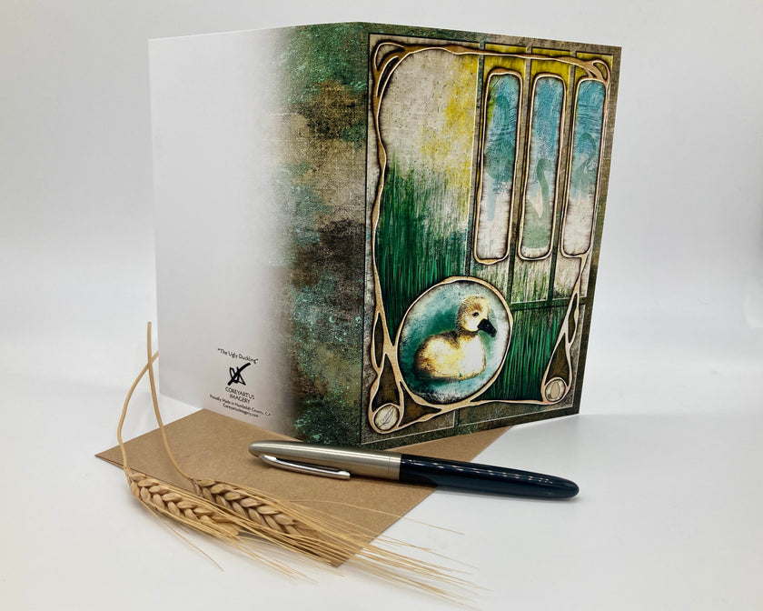Decorative greeting card with artistic design, pen, and paper on a white background