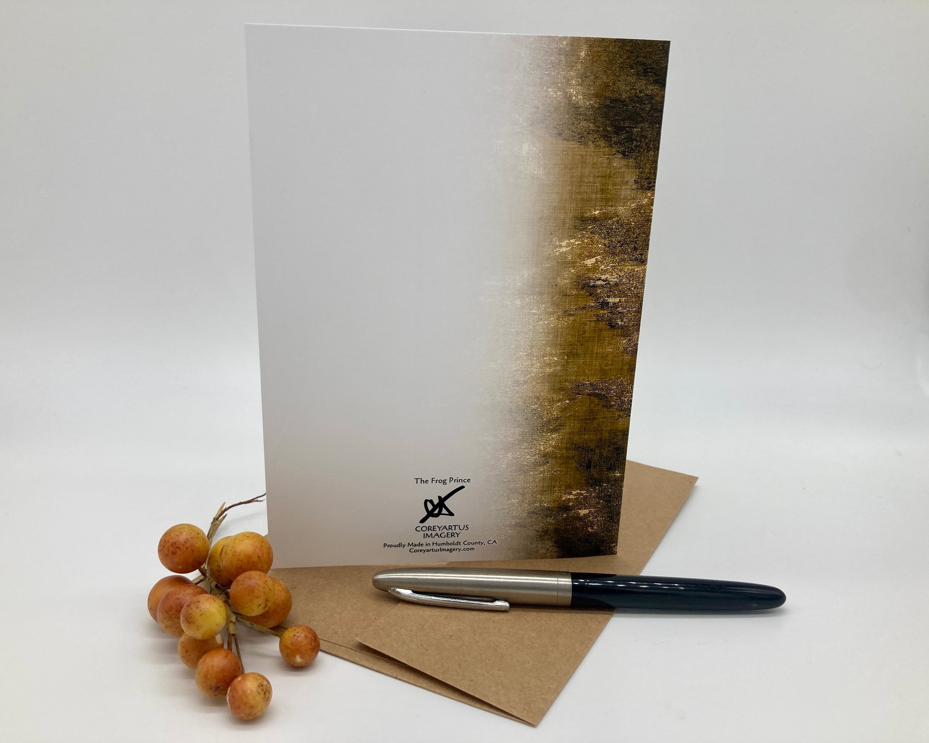 Greeting card with envelope and pen on a white background