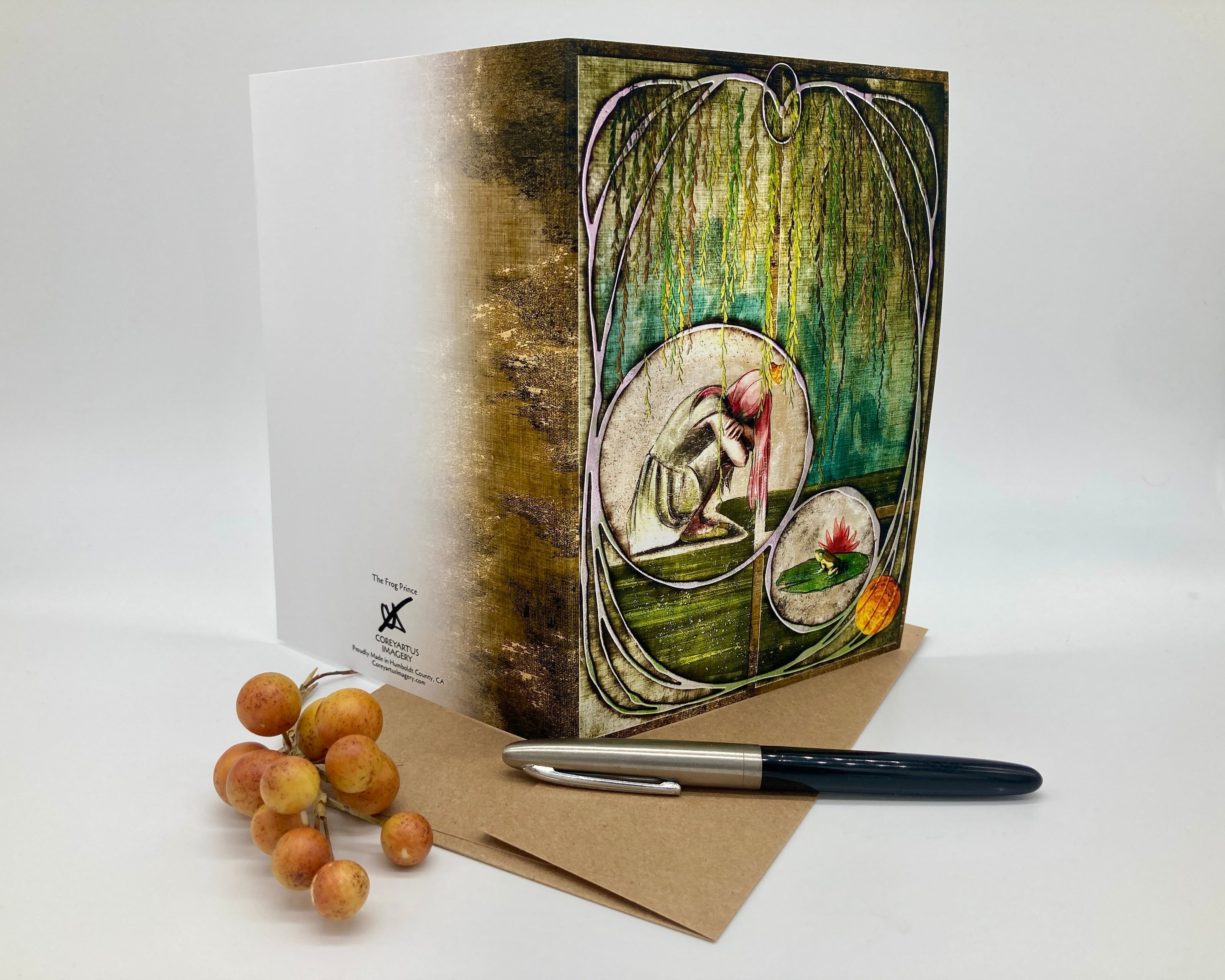 Greeting card with artistic design, pen, and dried fruits on a white background