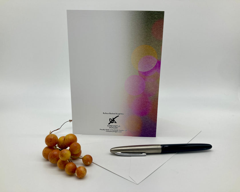 Greeting card with colorful design, pen, and envelope on a white background