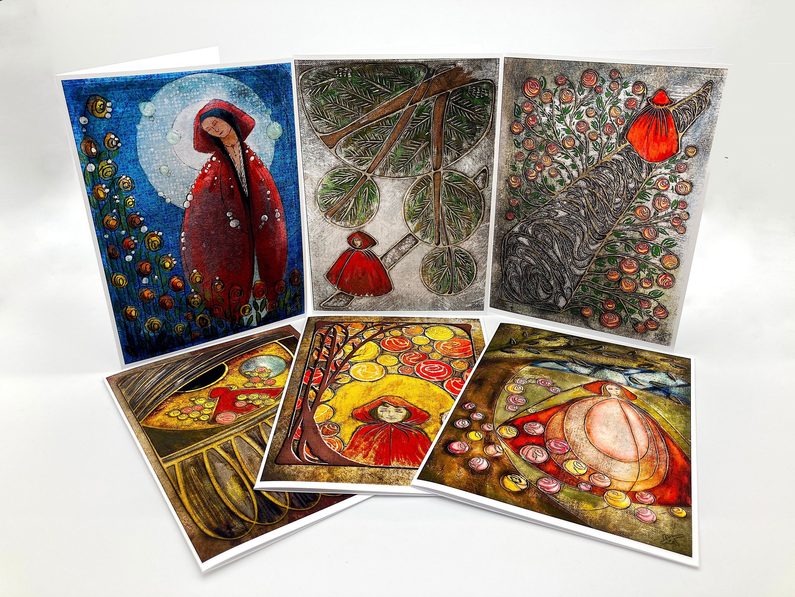 Set of six artistic greeting cards with various designs on a white background