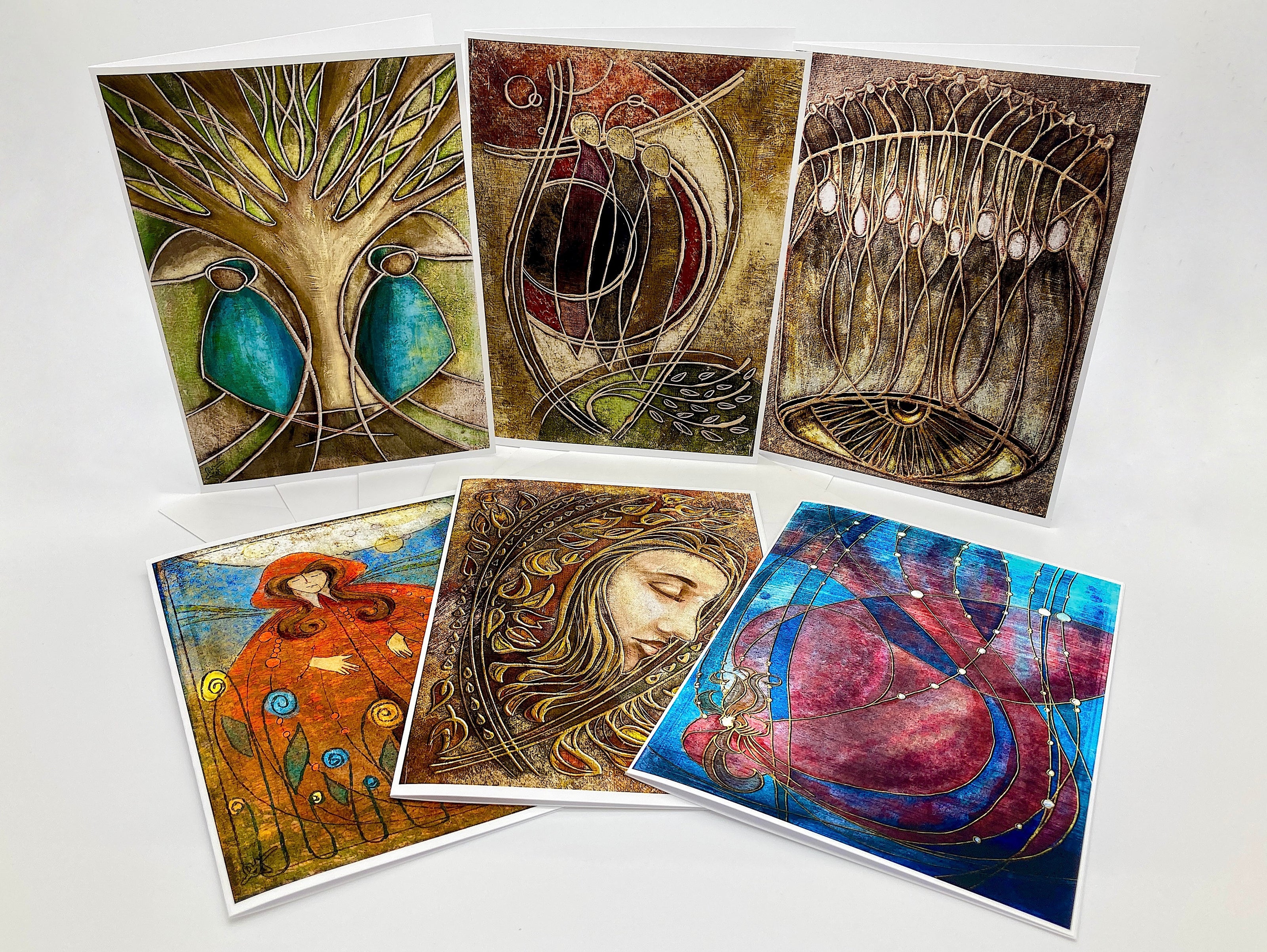 Set of six artistic greeting cards with various designs on a white background