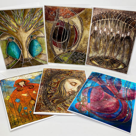 Set of six artistic greeting cards with various designs on a white background