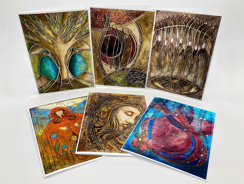 Set of six artistic greeting cards with various designs on a white background