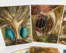 Set of abstract art cards with nature-themed designs on a white surface.