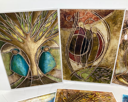 Set of abstract art cards with nature-themed designs on a white surface.
