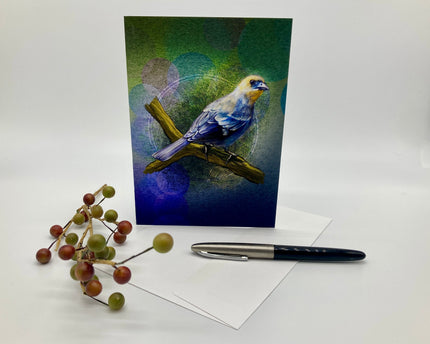Greeting card with a bird illustration on a white surface with berries and a pen.