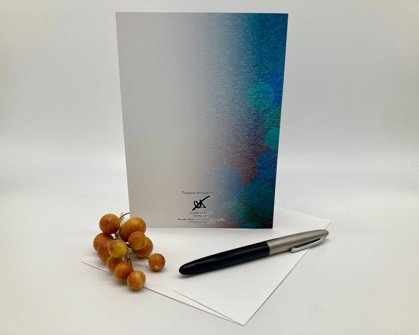 Greeting card with artistic design, pen, and grapes on a white background