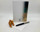 Notebook with a pen and grapes on a white background