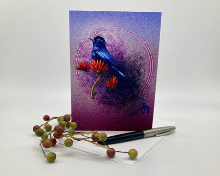Greeting card with a blue bird design on a purple background, accompanied by a pen and decorative branches.