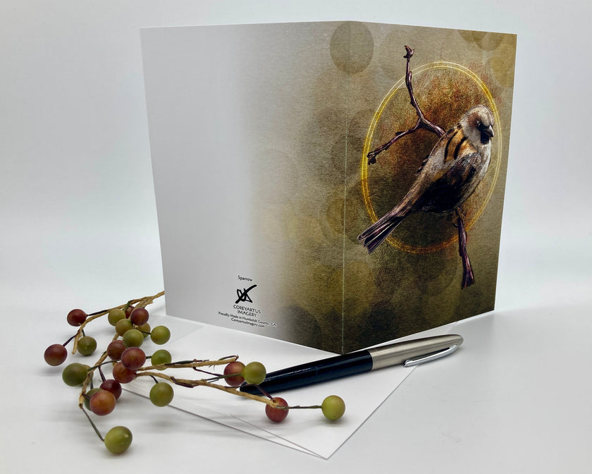 Greeting card with bird design on a white surface with berries and pen