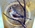 Bird perched on a branch with a wooden background