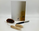 Pen, decorative elements, and a card with a brand logo on a white background