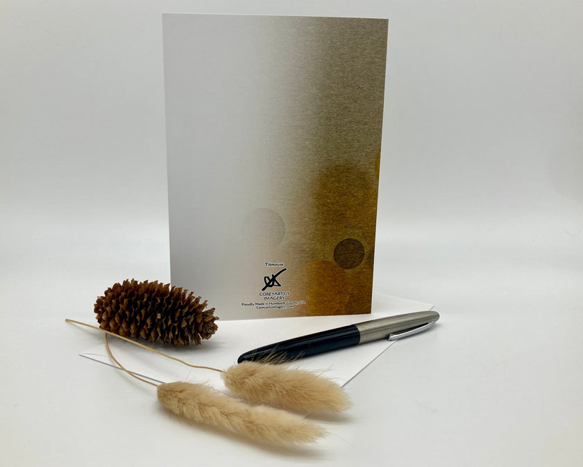 Pen, decorative elements, and a card with a brand logo on a white background