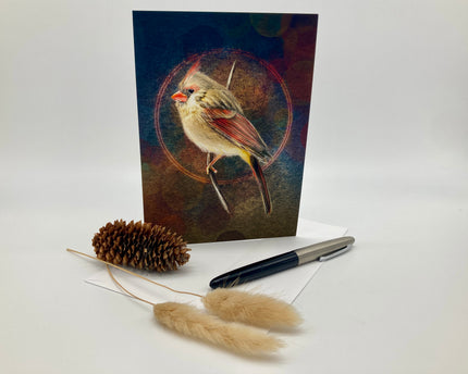 Greeting card with a bird design, pen, and decorative items on a white background