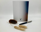 Greeting card with pen and decorative elements on a white background